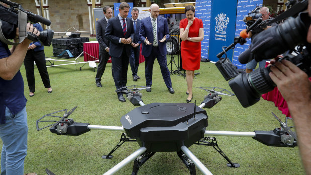 Queensland Premier Annastacia Palaszczuk and Minister for State Development Cameron Dick (front left) inspect the drones developed by Boeing.