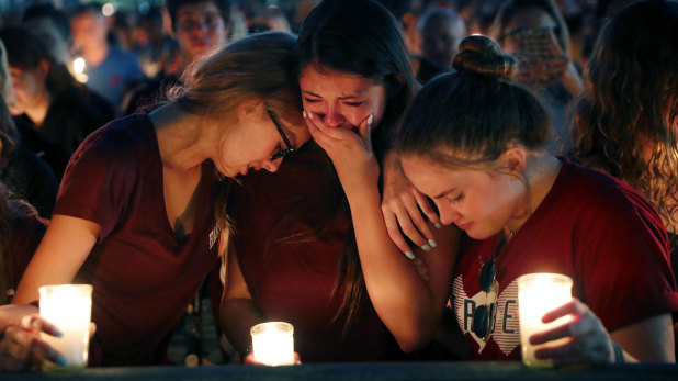 Students weep during a candlelight vigil for the victims at Marjory Stoneman Douglas High School.