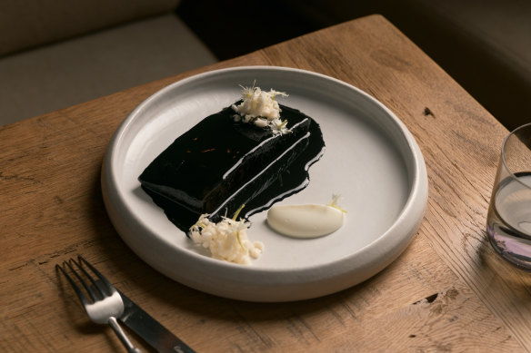 Squid ink glazed toothfish, cauliflower and phlox flowers.
