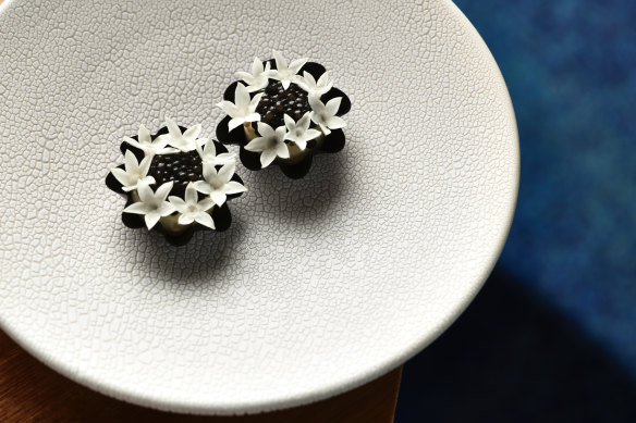 Amuse-bouche tarts filled with whipped creme fraiche and topped with oscietra caviar.