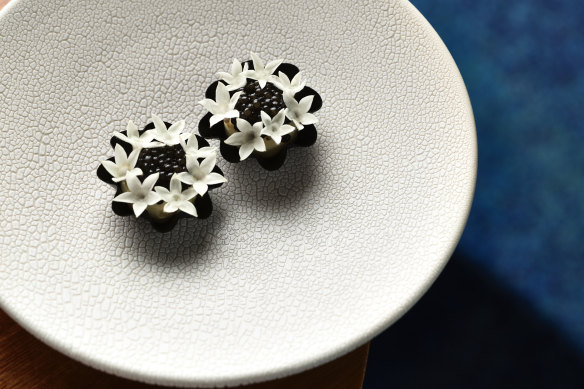 Amuse-bouche tarts filled with whipped creme fraiche and topped with oscietra caviar.