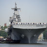 Sailors and military service personnel arrive on the USS Wasp amphibious assault ship on the Hudson River during fleet week in New York.