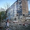 Residents embrace after a Russian missile hit an apartment building in Kyiv, Ukraine, last month.