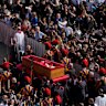 The ceremony with the Pope Francis’ body, who will lie in state at St. Peter’s Basilica for three days, pass through the crowd at the Vatican, Wednesday, April 23, 2025. (AP Photo/Gregorio Borgia)