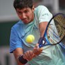 Australia’s Alexei Popyrin hits a backhand against Japan’s Yoshihito Nishioka.