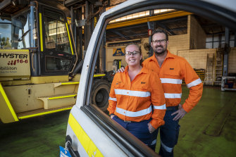 Toni McMahon and husband Clint at the Light Vehicle workshop at BHP's Nelson Point facility in Port Hedland. 