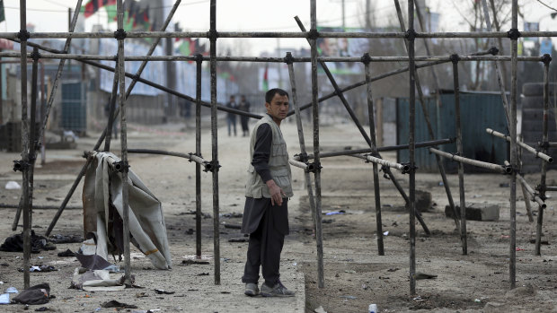 A man stands at site of the suicide attack in Kabul on Friday.