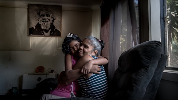 Mary Edwards with daughter, Regina, and a portrait of Mary's father Reg on the wall. 