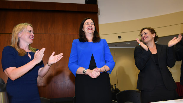 Queensland Premier Annastacia Palaszczuk, pictured with Kate Jones and Jackie Trad received a standing ovation from Labor MPs.