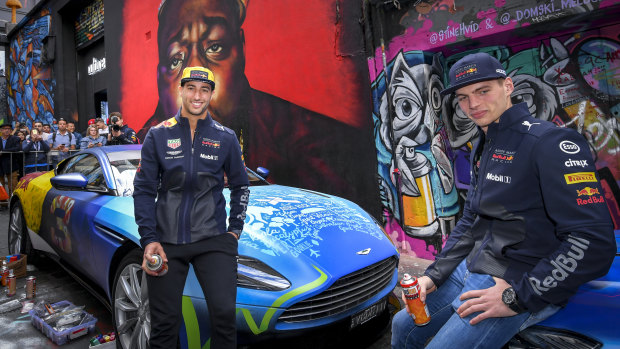 F1 drivers Daniel Ricciardo and Max Verstappen with the work of street artist Julian Clavio.