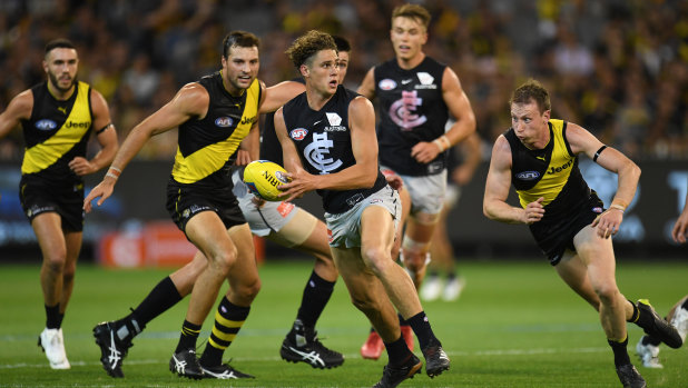 Breaking out: Carlton's Charlie Curnow comes through the pack in possession.