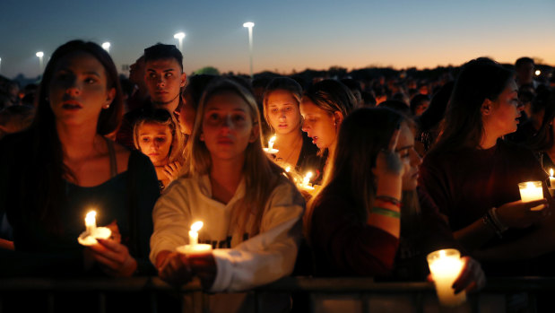People attend a candlelight vigil for the 17 victims on Thursday night.