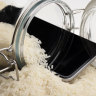A wet smartphone is dried in rice and glass bottle.