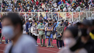 People line up to get vaccinated at the Gelora Bung Karno Main Stadium in Jakarta.
