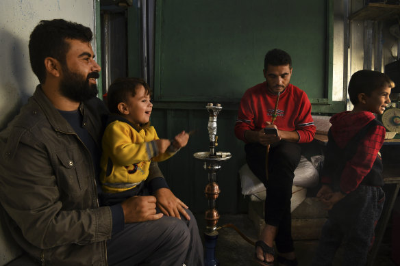 Pastry cook Issa Abdulqadir with his six year old son Hozen (right) his brother Daham Abdulqadir (left) and his son Mohammad in Basirma refugee camp in Iraq.