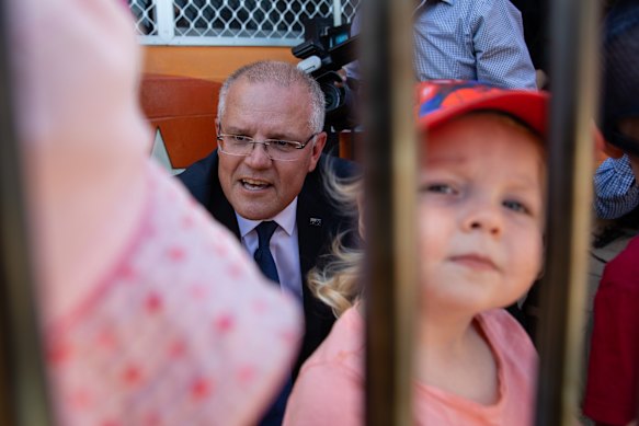 Prime Minister Scott Morrison meets children from a nearby school following a press conference in Carlisle on Thursday.