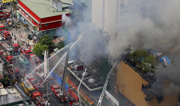 Fire crews battle a fire at the  Manila Pavillion Hotel on Sunday.