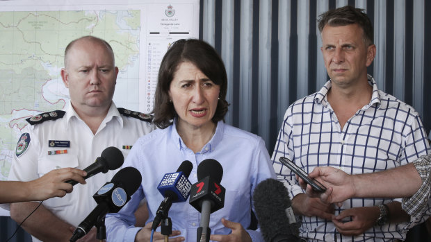 RFS Commissioner Shane Fitzsimmons, NSW Premier Gladys Berejiklian and NSW Member for Bega Andrew Constance address the media during a  visit to the Bega Valley Rural Fire Service on Monday.