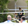 Police officers inspect items outside the property on James Street, Mordialloc on Thursday afternoon.