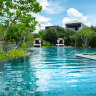 Hotel pool and villas surrounding it.