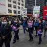 Unionised nurses and midwives arrive at Sydney Town Hall for their meeting on Tuesday.