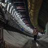 A worker walks through one of the twin tunnels being constructed under Rosehill Racecourse near Parramatta.