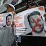 Malaysian protesters display placards during a demonstration against the US envoy nominee Nick Adams outside the US embassy in Kuala Lumpur last week.