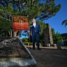 David Laird stands ready beneath the Lonesome Pine with “Clarrie’s Flag”, the banner of the 7th Battalion, for the early Anzac ceremony at Wattle Park.