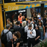 Commuters wait in a snaking line for B-line buses to the northern beaches at Wynyard station.