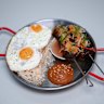 Tapsilog: beef skewers, eggs, garlic rice, banana ketchup and pickles.