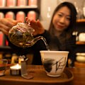 Founder of Ms. Cattea Cathy Zhang prepares Nine Mountains green tea on a candle burner.