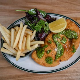 Chicken schnitzel with caper salsa, chips and salad.