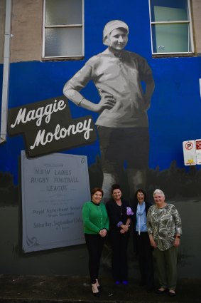 Rugby league player Maggie Moloney’s four granddaughters Karen Heard, Tracey Heard, Margaret Heard and Maureen Black stand at a mural dedicated to their grandmother in Redfern.