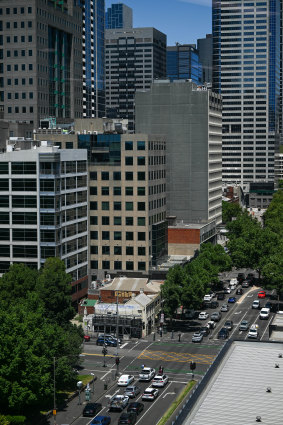 The tiny shop-and-dwelling has gradually been dwarfed by towers that have grown around it.