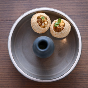 Pani puri filled with spiced potato, chickpeas, tamarind chutney and aromatic water. 