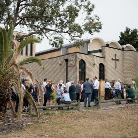 People gather outside the Macedonian Orthodox Church of St Kiril i Metodi in Sydney.