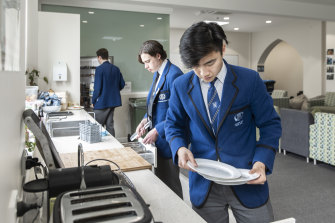 Boarders clean up the kitchen at Knox Grammar.