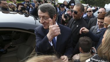 Nicos Anastasiades  waves to his supporters after he voted in the presidential elections in southern coastal city of Limassol, Cyprus, on Sunday.