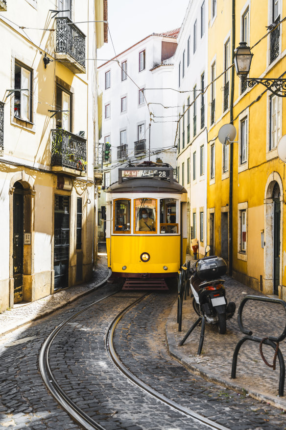 One of Lisbon’s yellow trams passes through a narrow street in the
Alfama district.