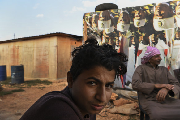 Mohammad, 14, sits with his father Abdelmeneim Moustafa, 54, in Saideh camp after a day shift at a construction site.