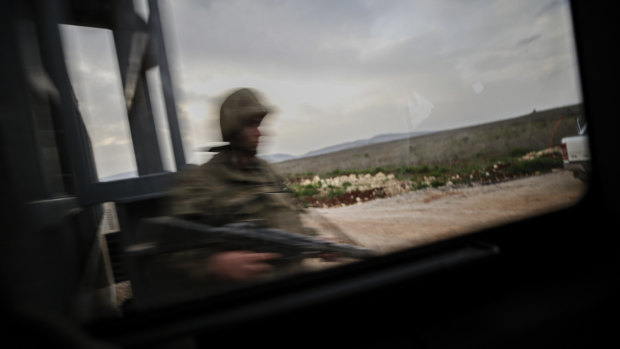 A Turkish soldier secures the border with Syria, in the outskirts of the border town of Kilis, on Saturday.
