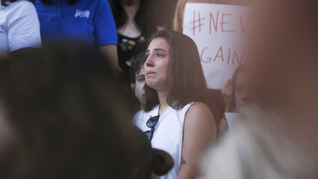 A young woman cries during a protest against guns on the steps of the Broward County Federal courthouse in Fort Lauderdale.