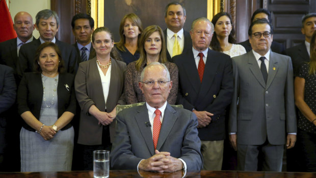 Pedro Pablo Kuczynski poses with his cabinet before addressing the nation and announcing his resignation.