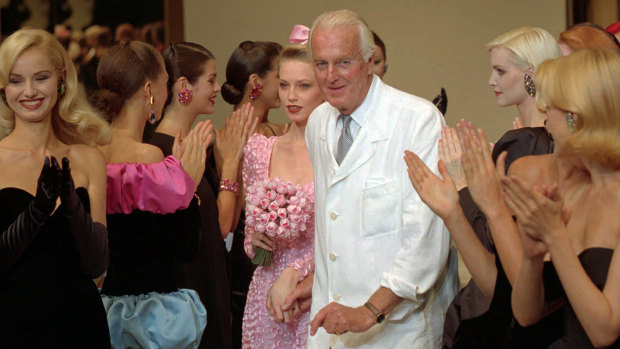 Hubert de Givenchy is applauded by his models after his 1995-96 fall-winter haute couture fashion collection in Paris. 