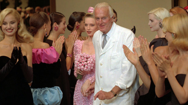 Hubert de Givenchy is applauded by his models after his 1995-96 fall-winter haute couture fashion collection in Paris. 