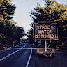 A sign on the road to Apollo Bay warns visitors of water restrictions.