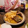Steak with “umami butter” is cooked over a wood grill.