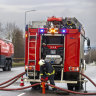 Lithuanian emergency personnel prepare to work near the site where a DHL cargo plane crashed into a house near Vilnius, Lithuania.