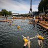 People swim at the Grenelle safe bathing site on the Seine river in Paris, France, Saturday, July 5, 2025, during the opening of the three Seine swimming pools, as part of the ‘Paris Plages’ event. (AP Photo/Thomas Padilla)