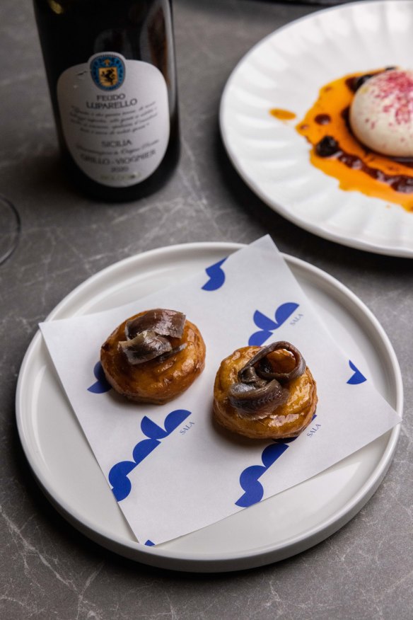 Ciambella glazed with black garlic and anchovies.